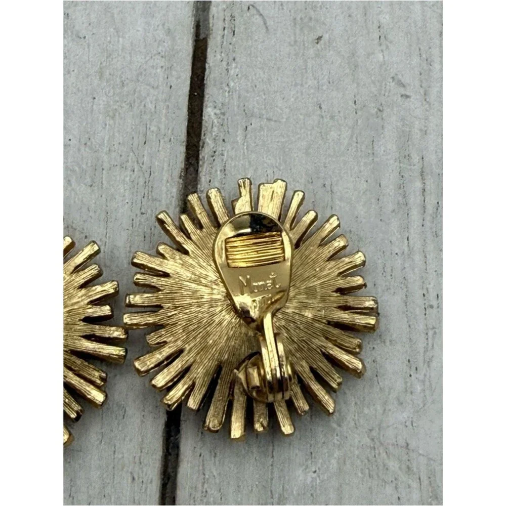 Vintage Monet gold tone starburst flower clip on earrings